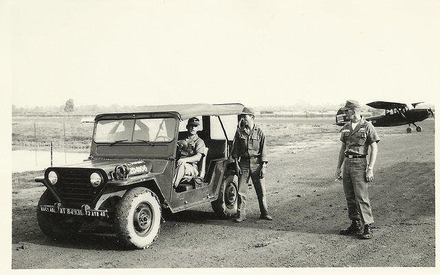 Tan Hiep, Jack Burden driving, Jack Byrnside on right, gas truck driver standing next to jeep