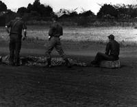 SP-4 Jim Groves and LT's Bauer and Helms assess the situation